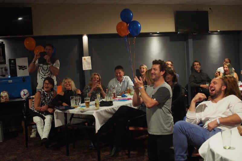 Audience enjoying a comedy hypnosis show at a small informal club event