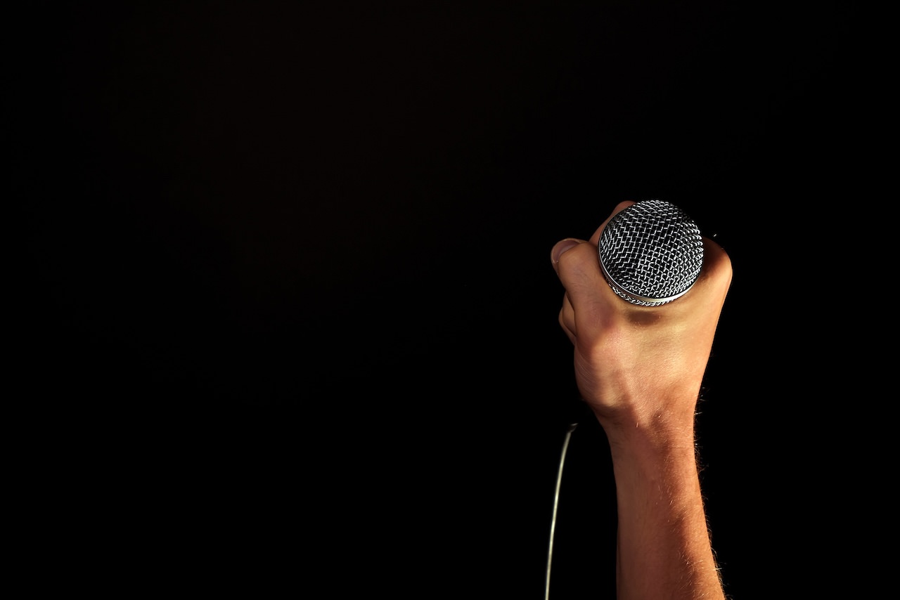 Hand Holding a Microphone