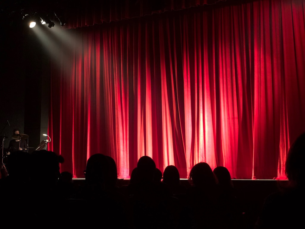 Empty Stage with Red Curtains